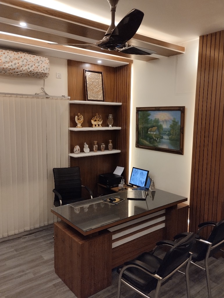 Doctor’s desk with laptop and guest chairs